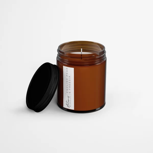 Artemis Candle Company Branded Soy Wax English Pear and Freesia Scented Candle Shown In Amber Glass Jar