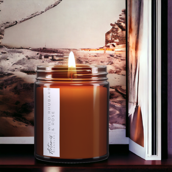 Artemis Candle Company Branded Soy Wax Wild Rhubarb and Rose Scented Candle Shown In Amber Glass Jar