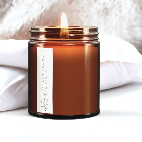 Artemis Candle Company Branded Soy Wax Fresh Laundry and Linen Scented Candle Shown In Amber Glass Jar